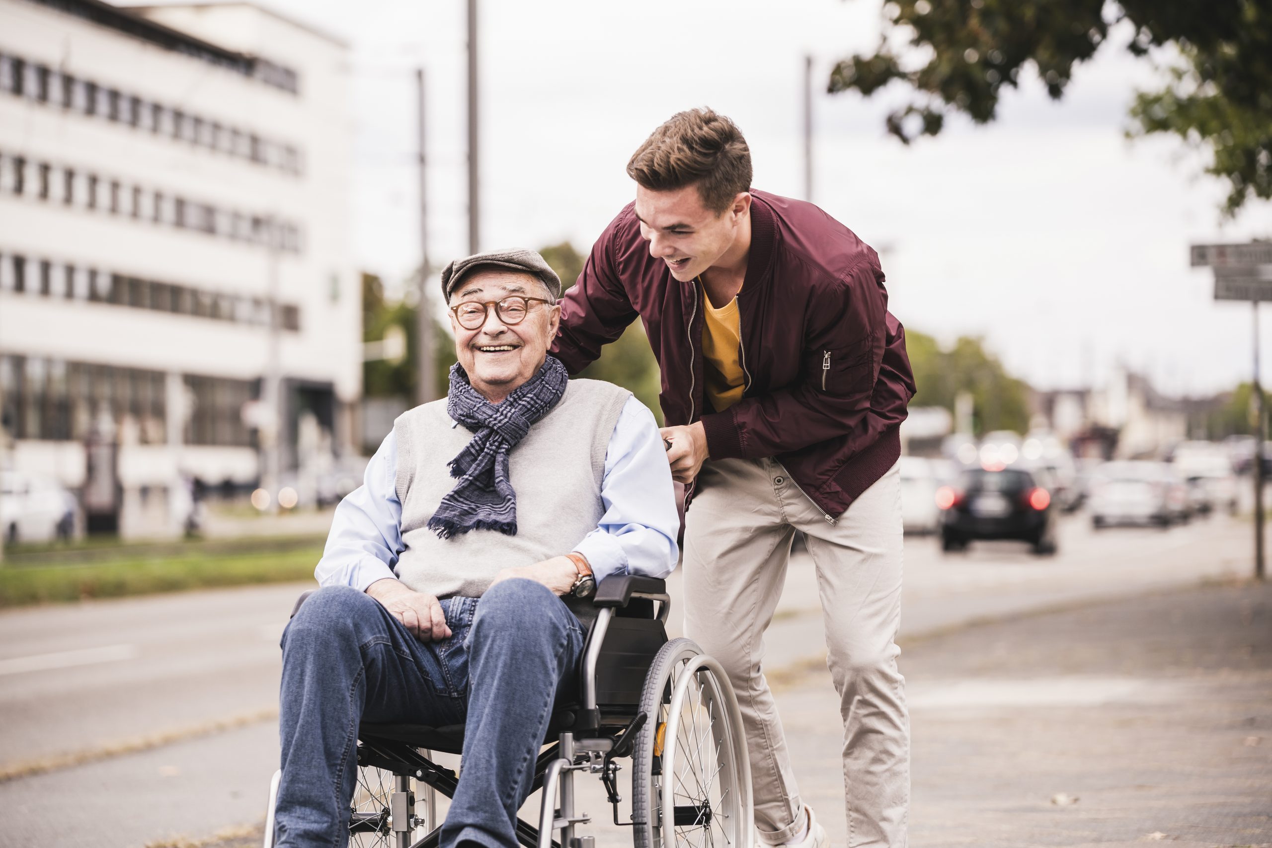 young-man-pushing-happy-senior-man-in-wheelchair-2022-03-08-01-34-22-utc-scaled-1 (1)